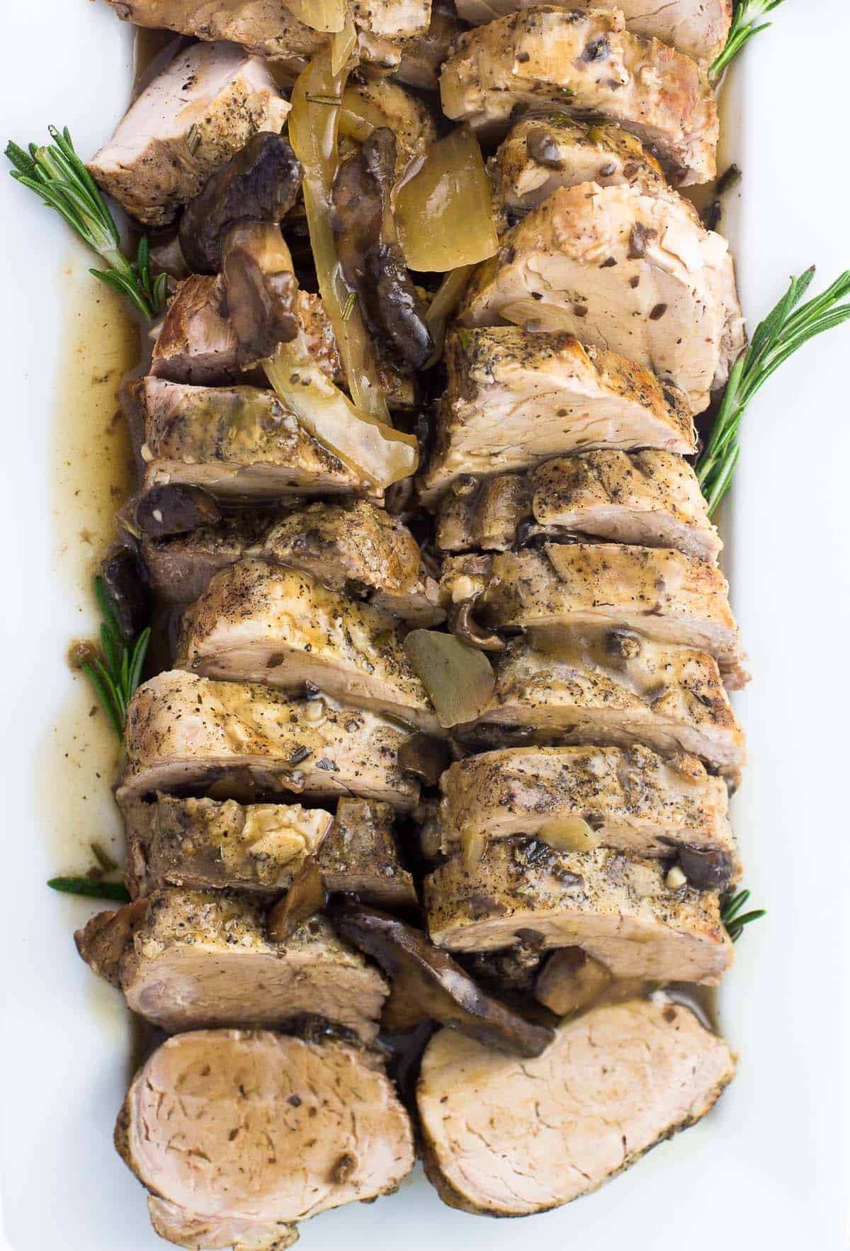 An overhead shot of sliced pork tenderloin on a serving plate.