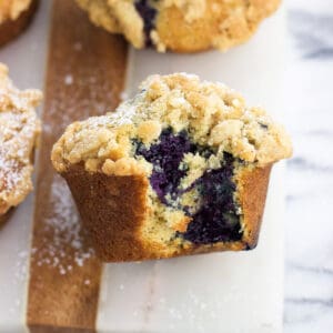 A blueberry muffin with a bite taken out of it
