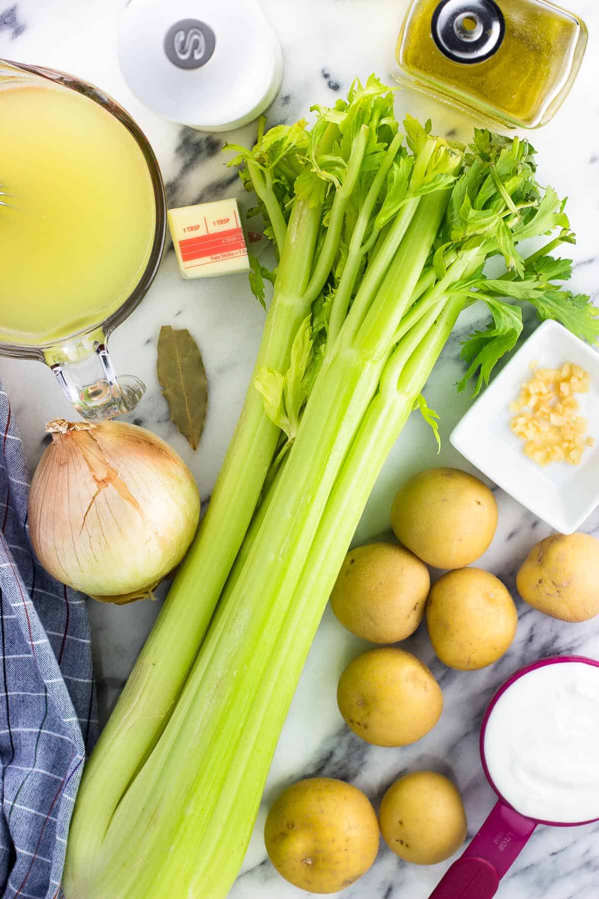 An overhead shot of the soup ingredients on a marble board.