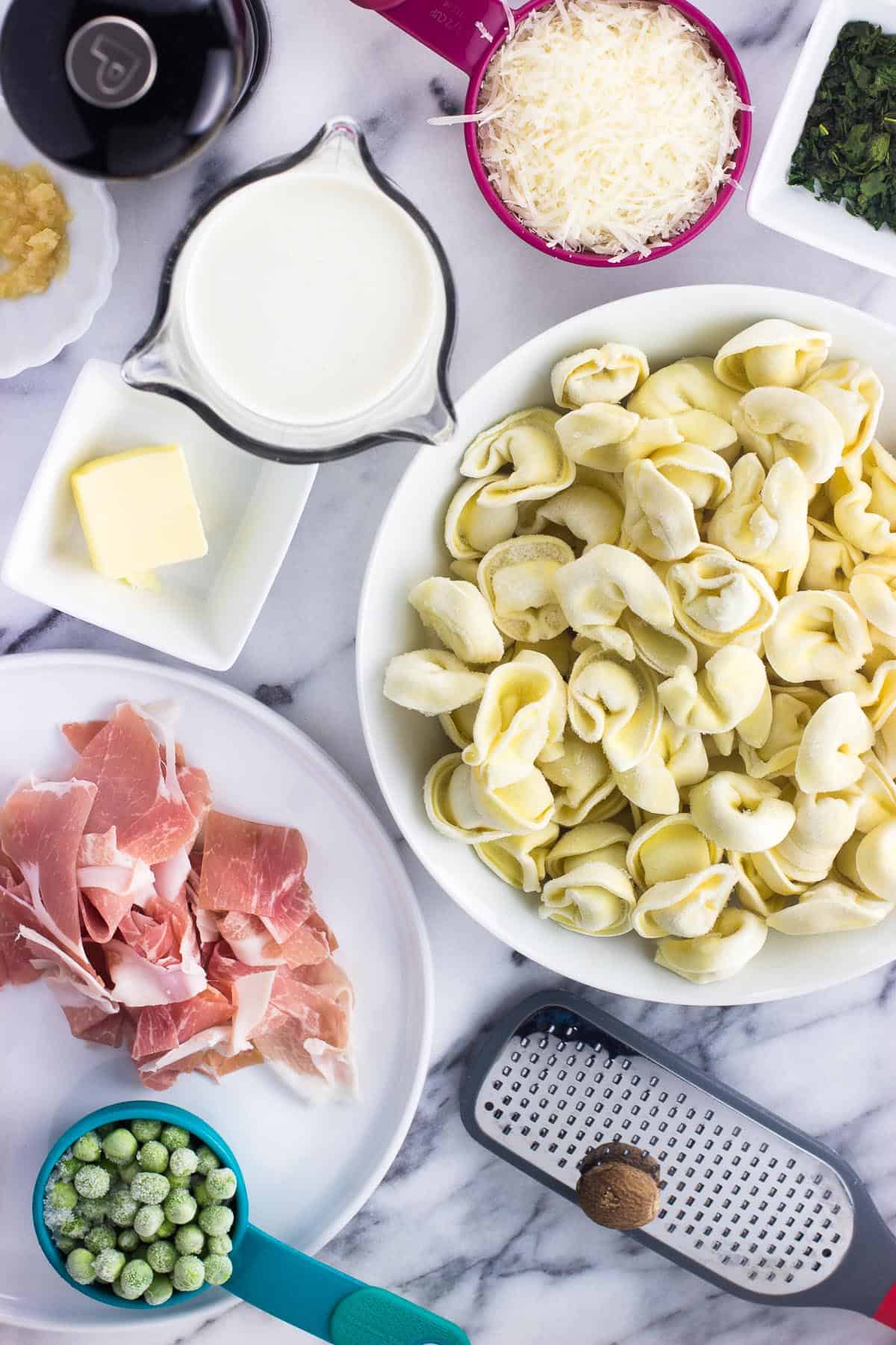 An overhead picture of all of the recipe ingredients in separate bowls and cups on a marble board