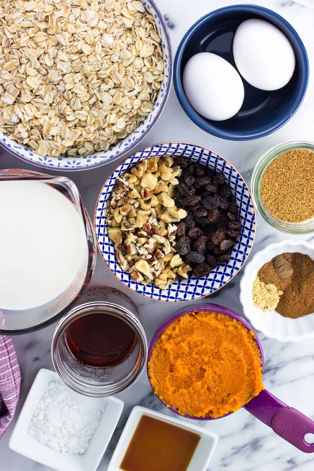 All recipe ingredients in separate jars, bowls, and measuring cups on a marble board