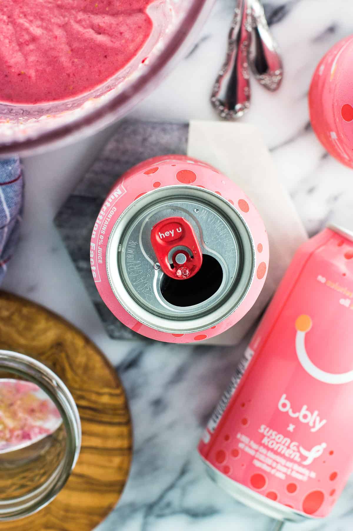 An open can of bubly grapefruit on a marble coaster.