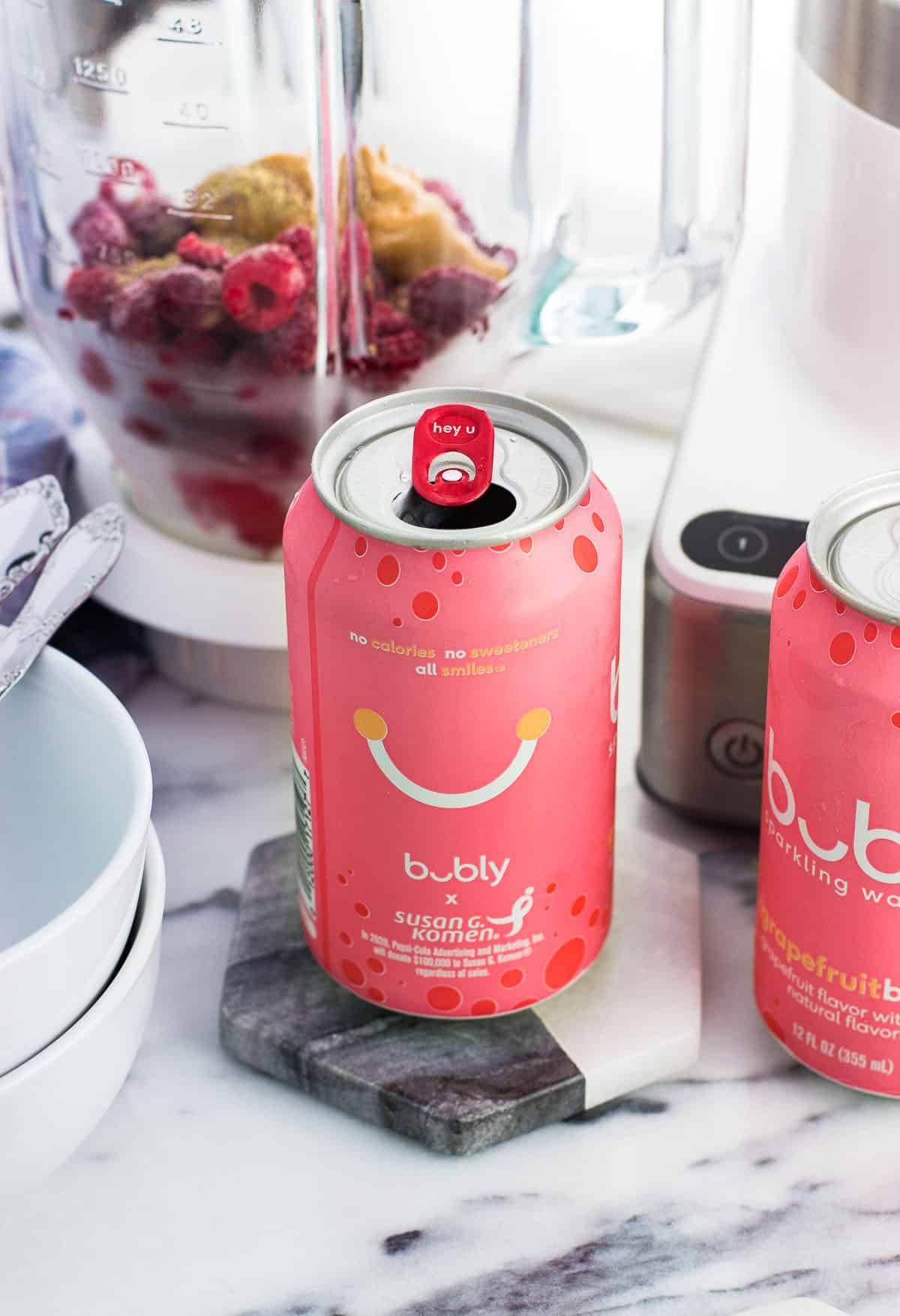 A can of grapefruit bubly next to bowls and a blender.