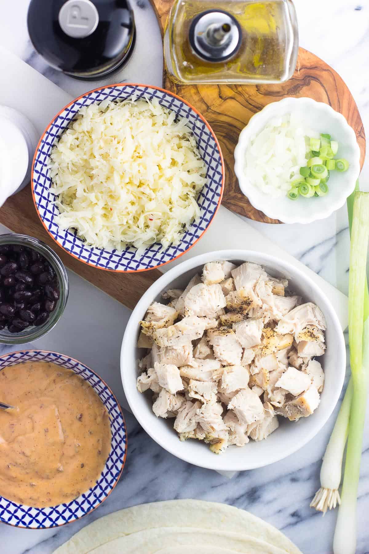 An overhead picture of the recipe ingredients in separate bowls on a marble board