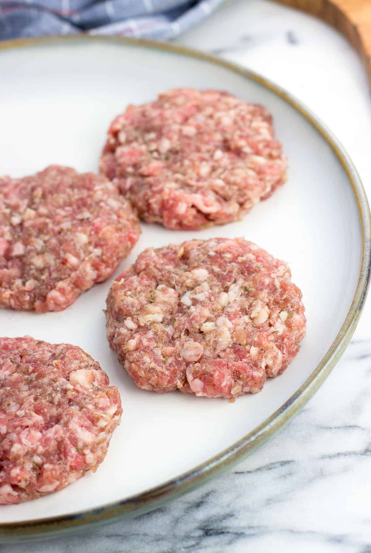 Formed patties on a large plate before being cooked