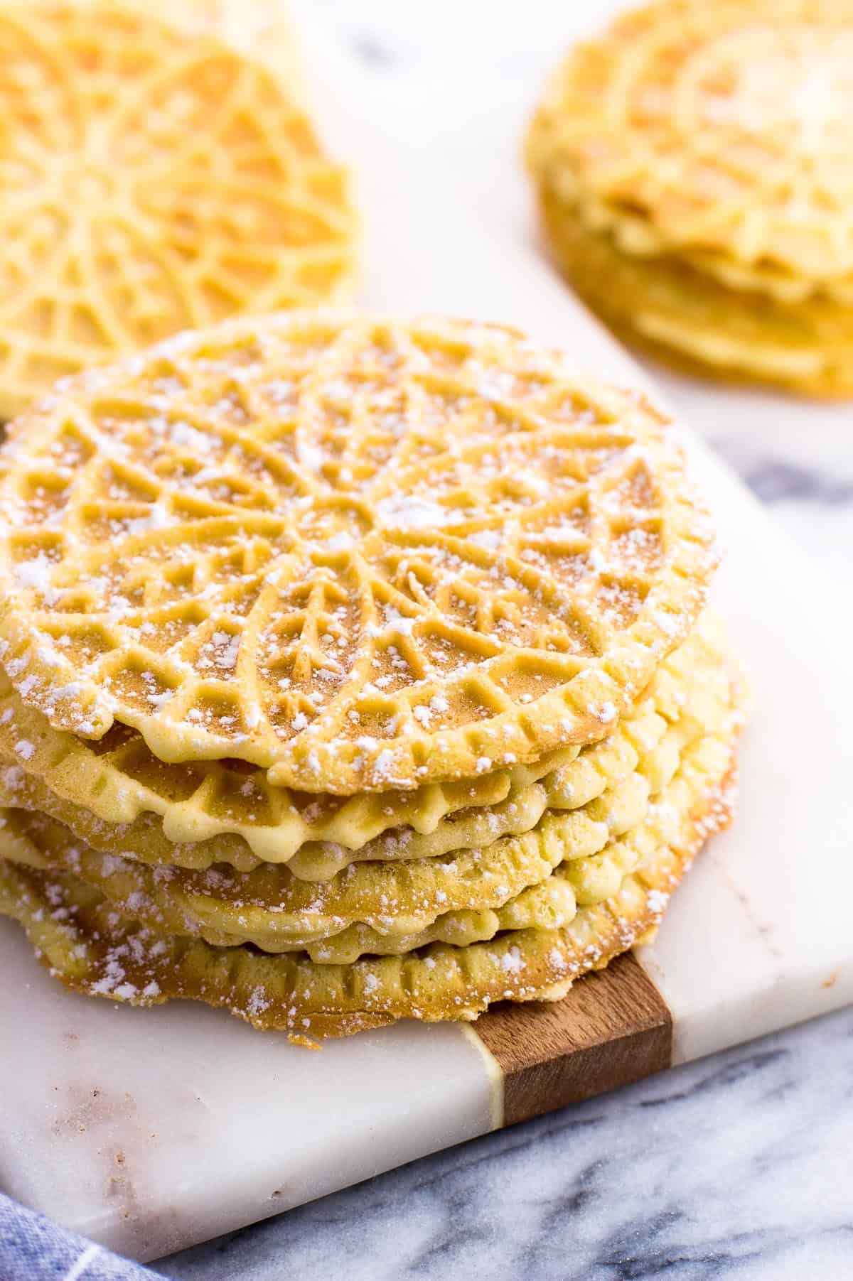 A stack of pizzelle on a marble board