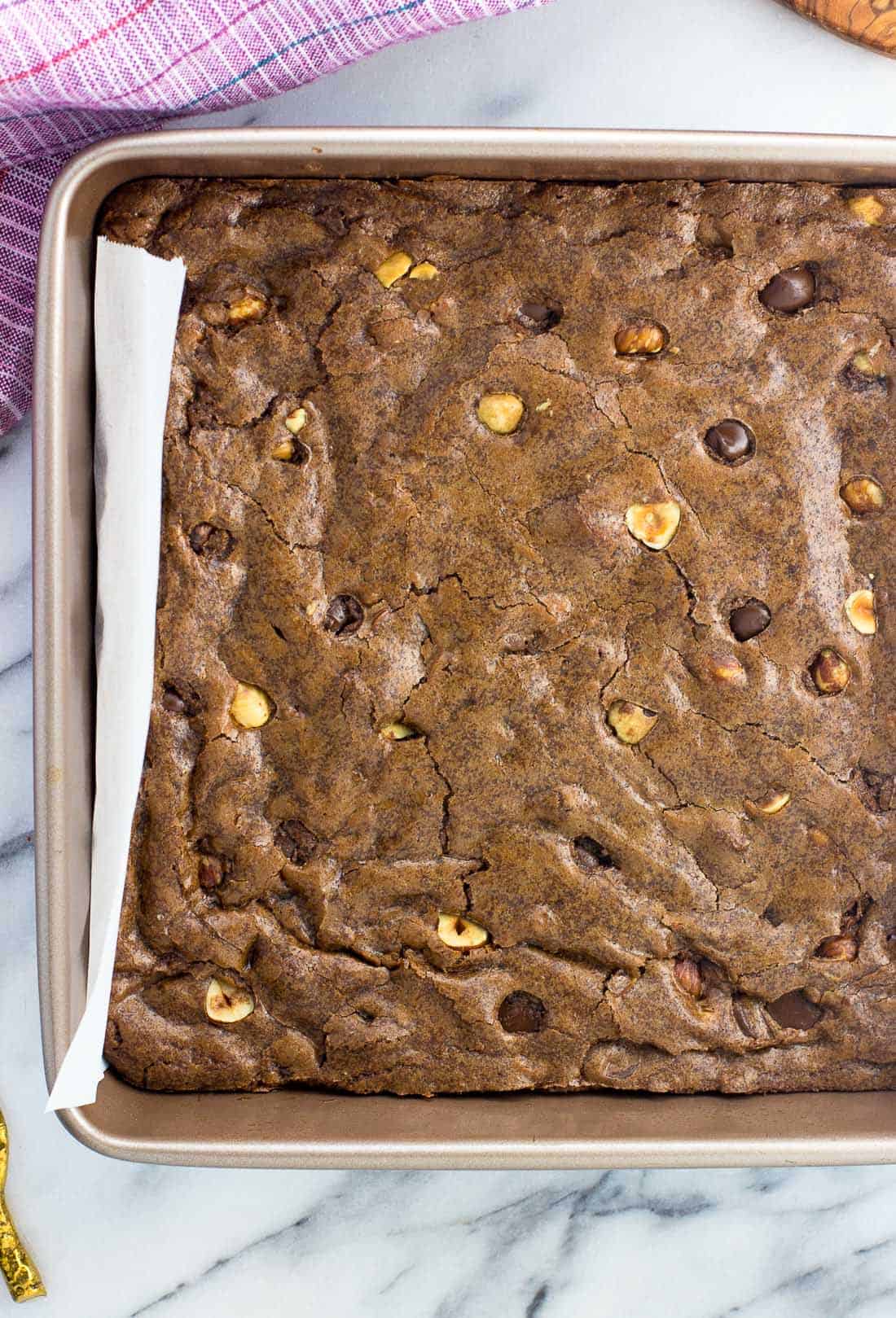 Hazelnut brownies baked in a pan before being sliced