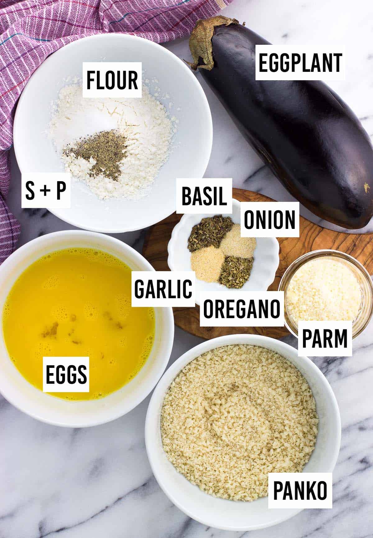 Recipe ingredients in separate bowls on a board.