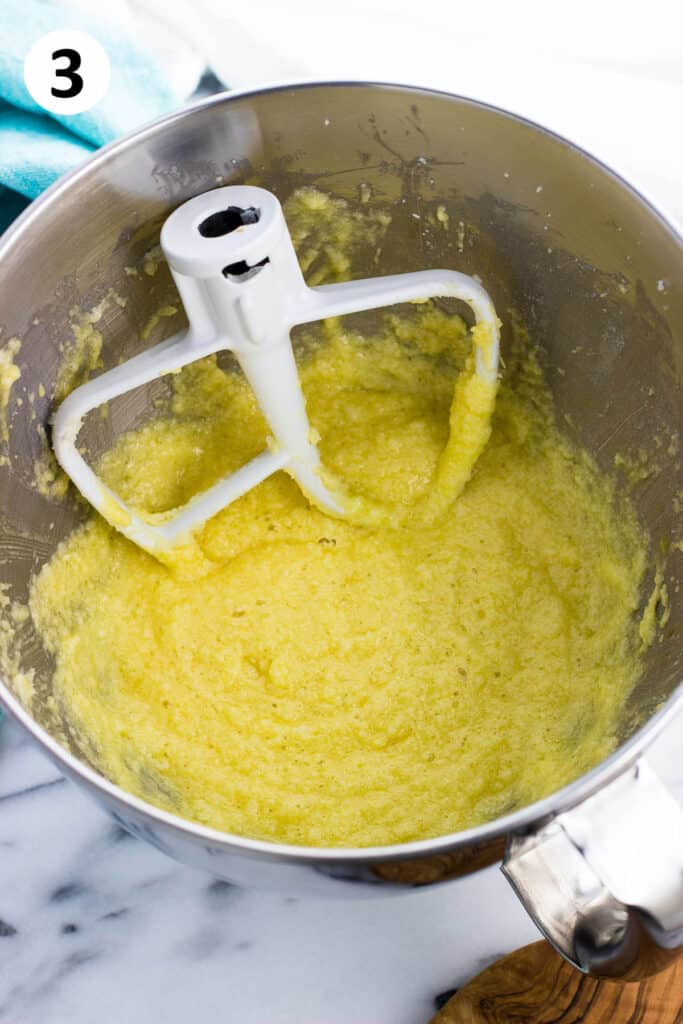 The batter partway through mixing in the bowl with the paddle attachment.