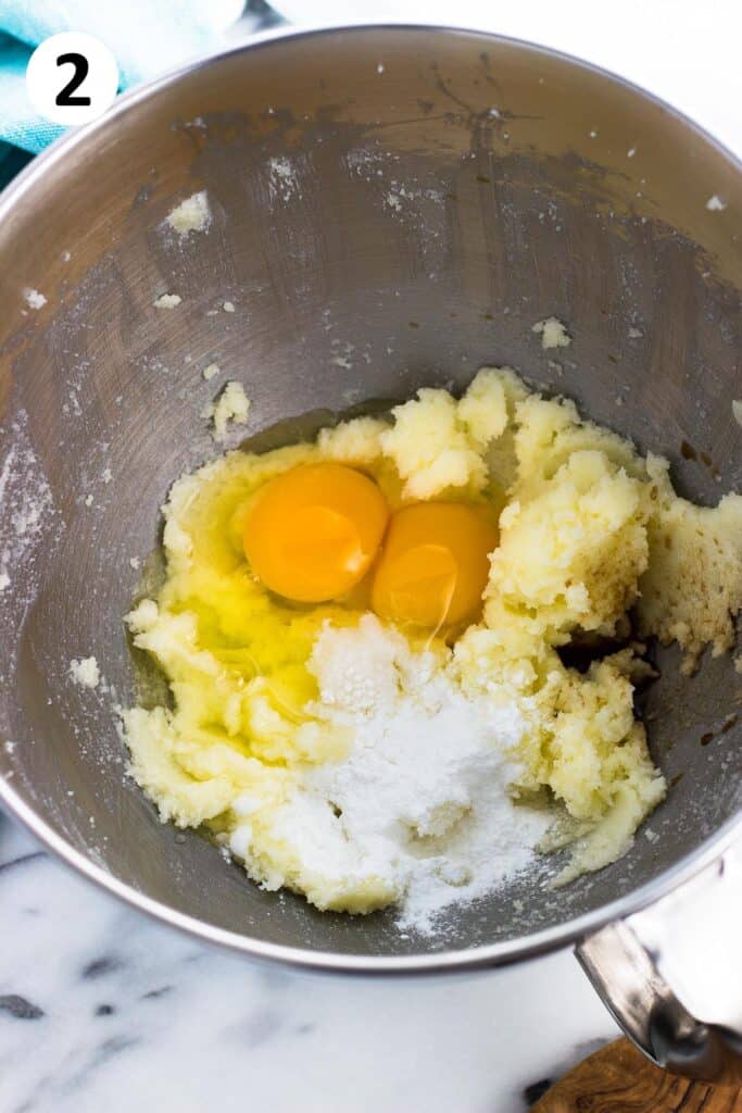 Eggs, vanilla extract, and leaveners added to the mixing bowl.