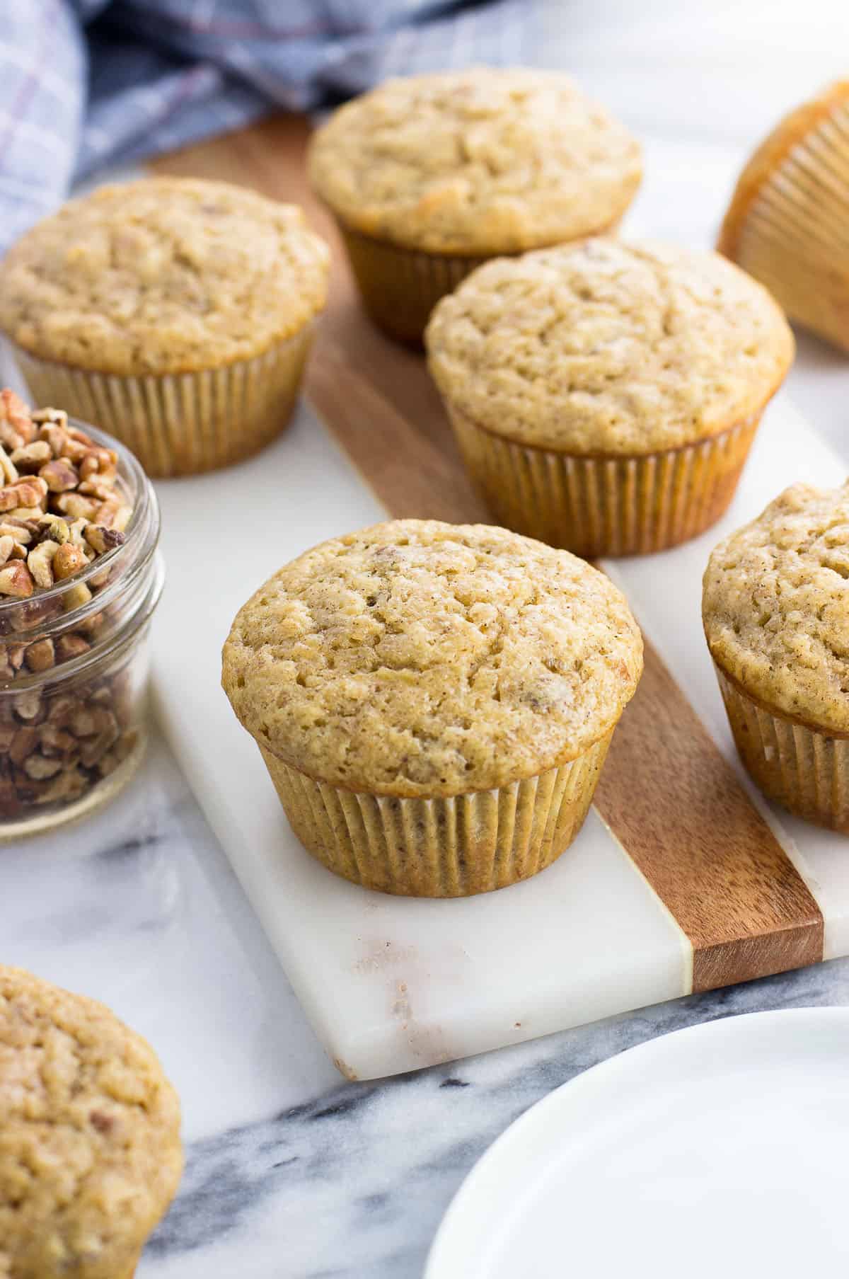 Banana nut muffins on a marble board.