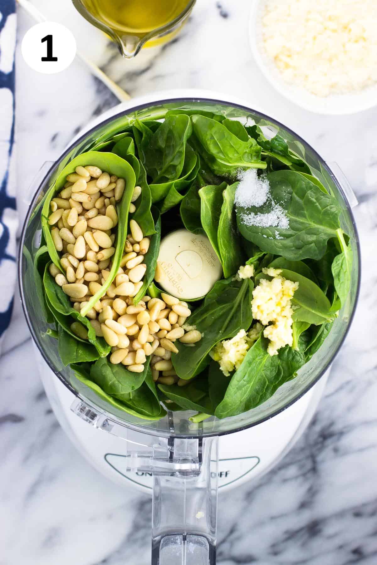 Recipe ingredients added to the bowl of a food processor.