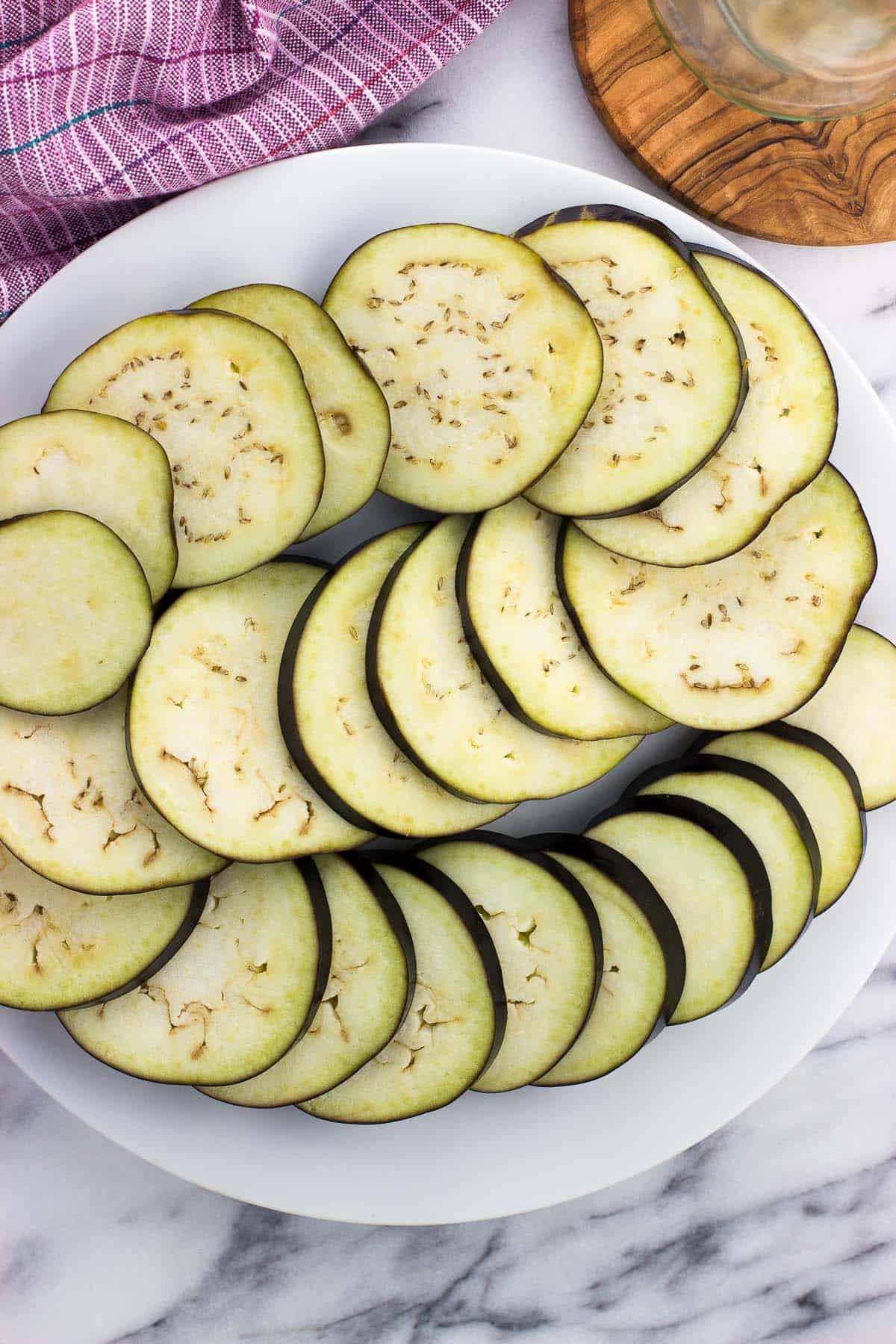 Eggplant slices laid out on a plate.