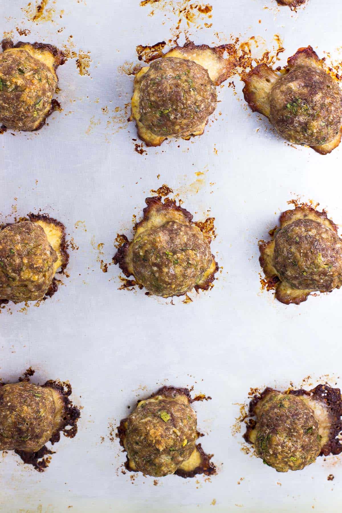 Cooked meatballs on a sheet pan.