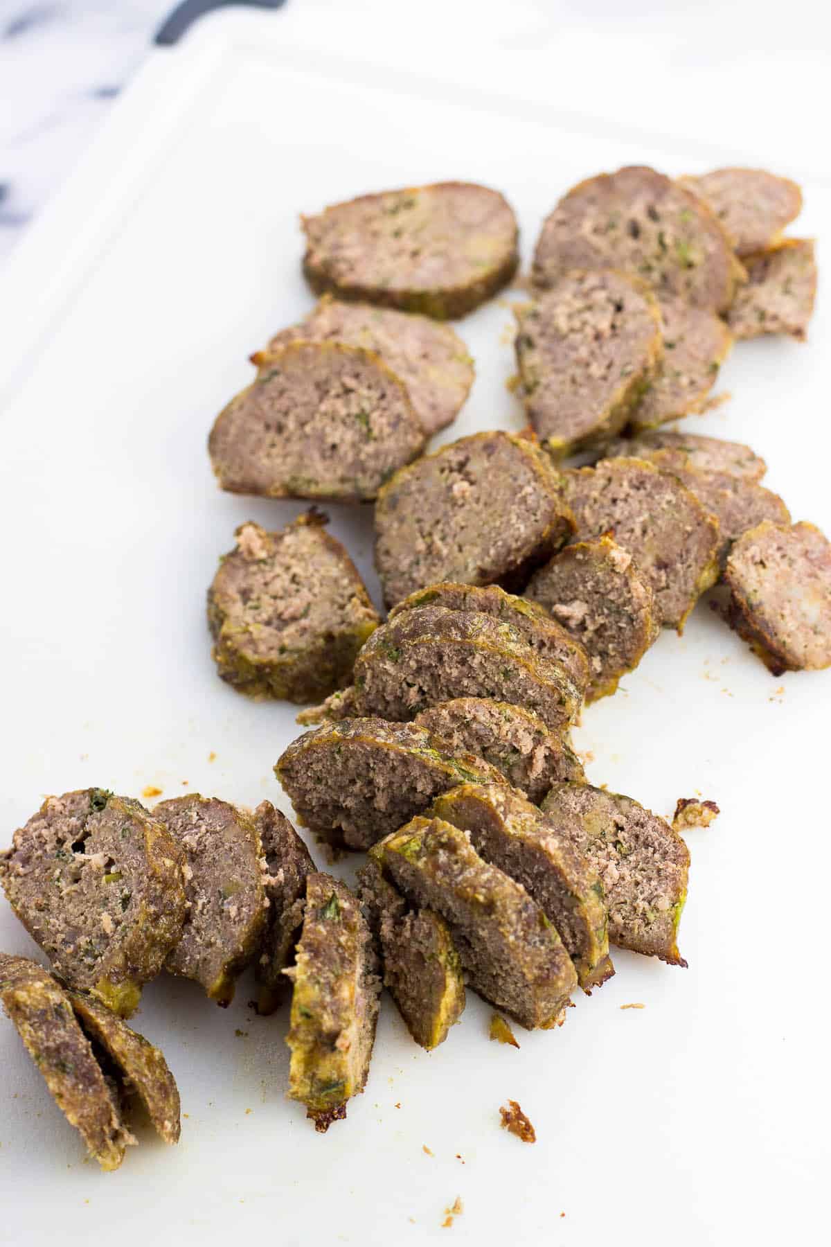 Sliced meatballs on a cutting board.