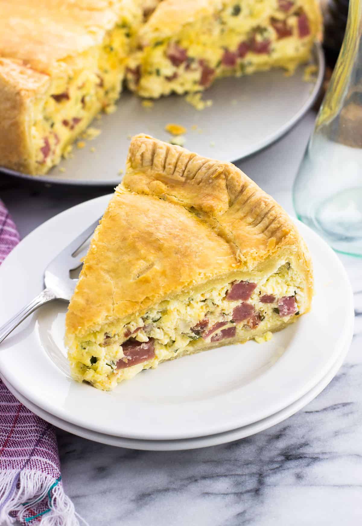 A slice of pizza rustica on a small plate.