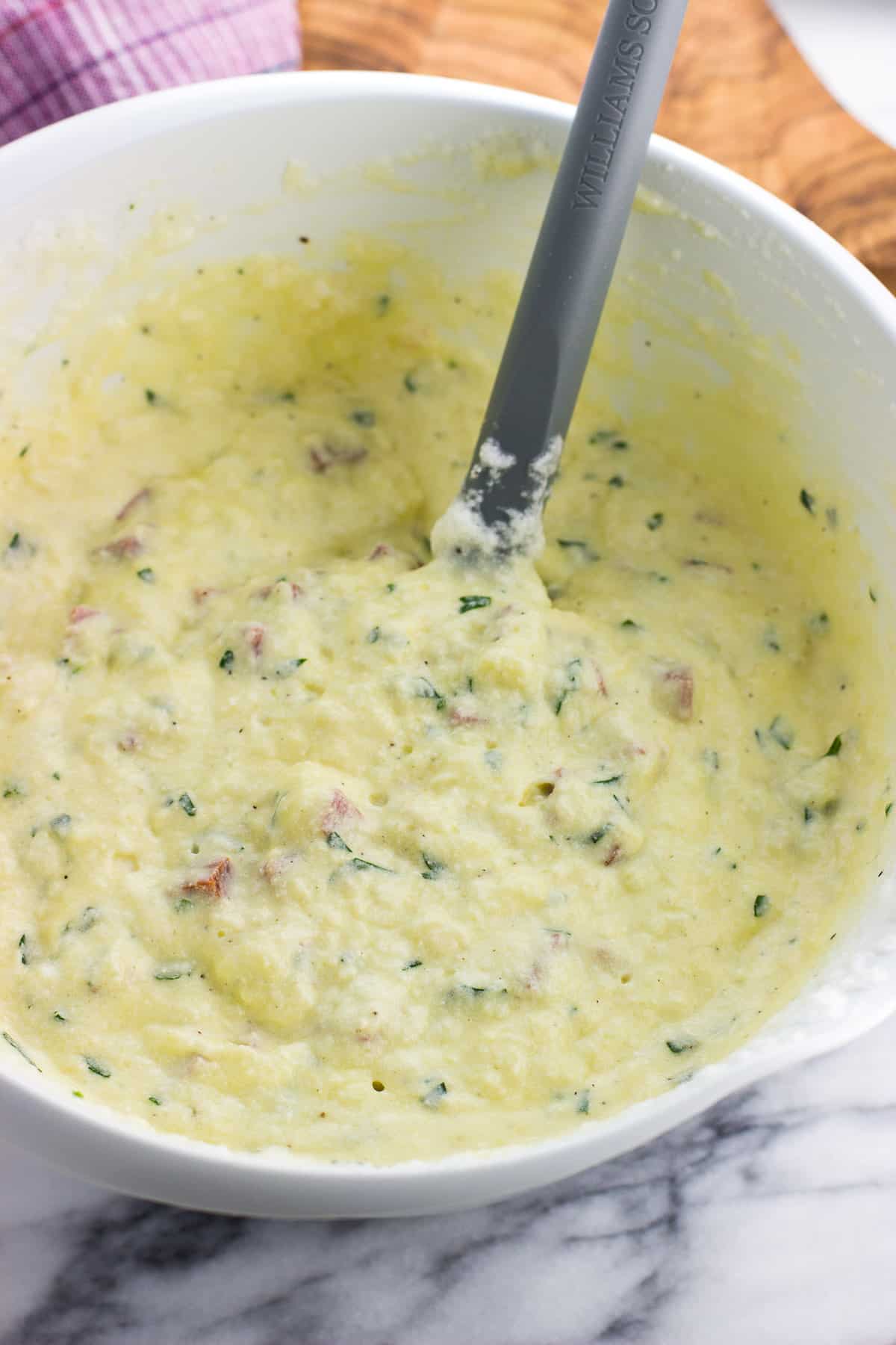 The filling ingredients mixed together in a large bowl with a spatula.