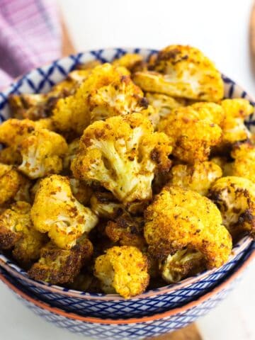 Air fryer cauliflower in a ceramic bowl for serving.