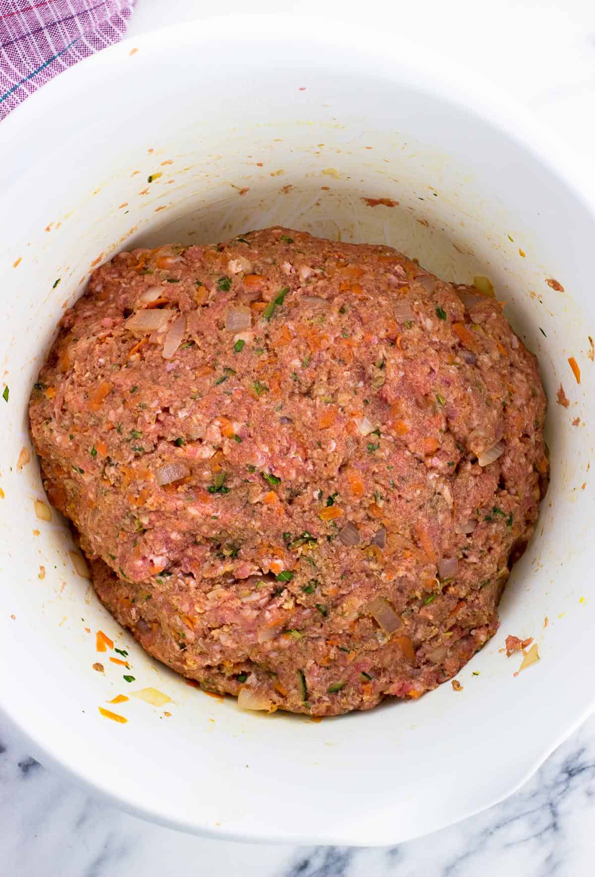 Meatloaf mixture combined in a mixing bowl.