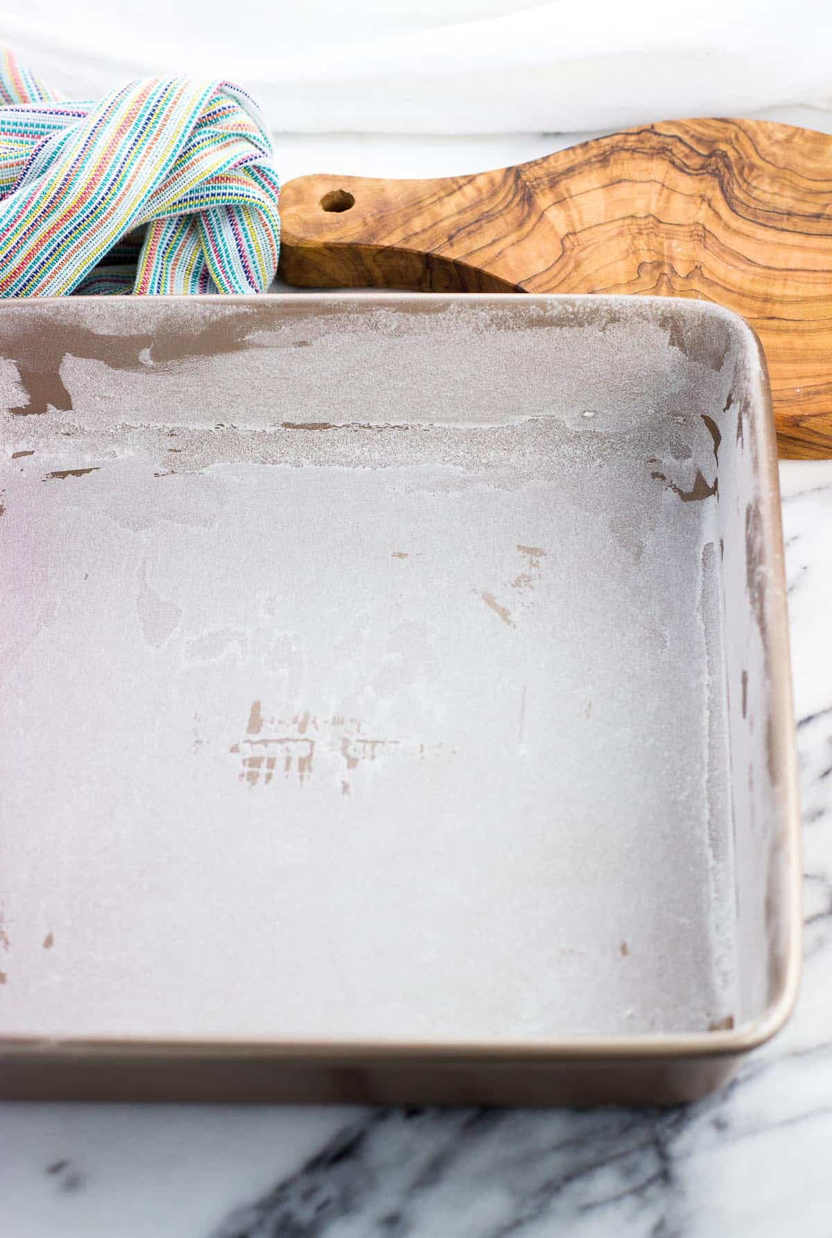 A greased and floured 8-inch square pan.