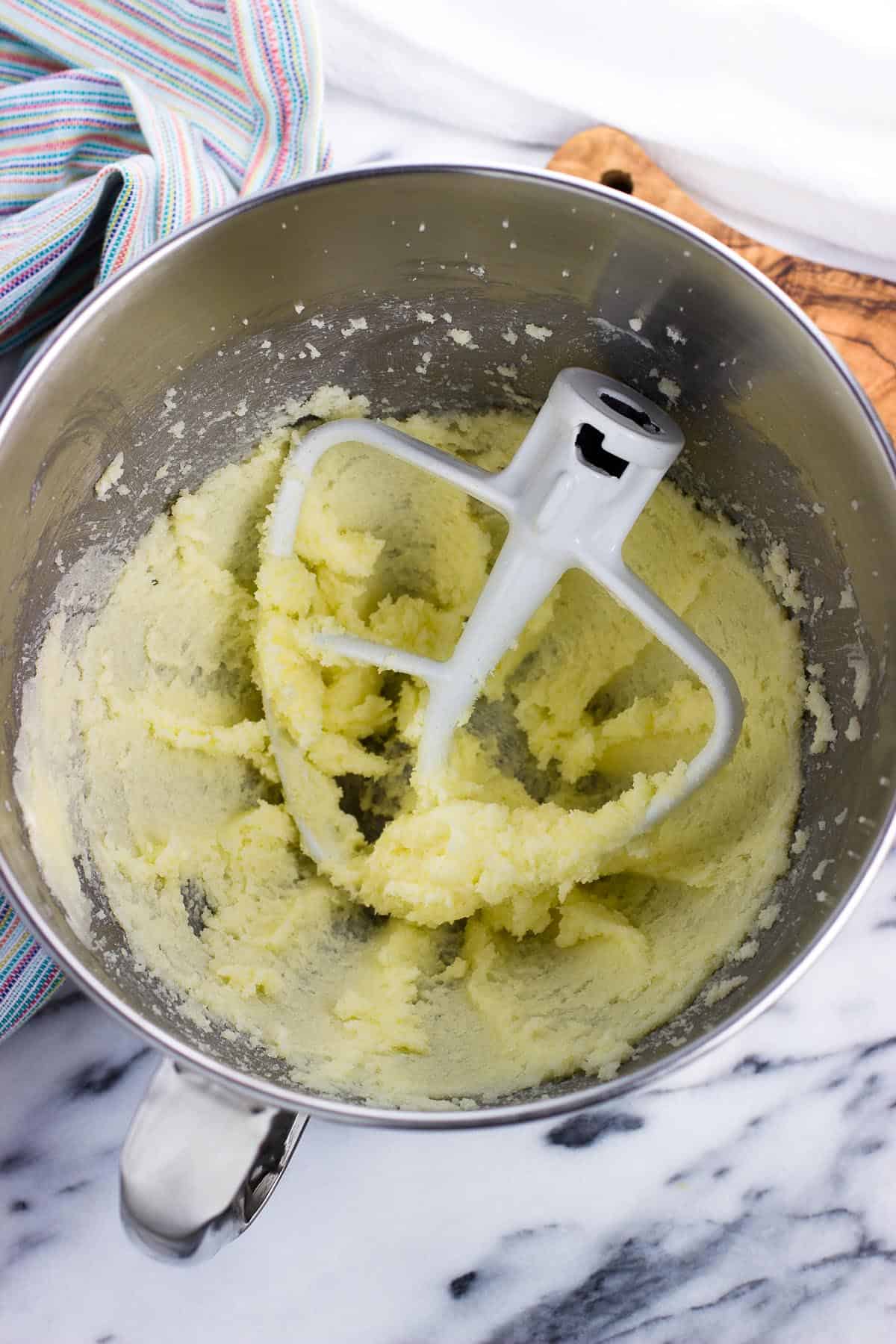 Creamed butter and sugar in a metal mixing bowl.