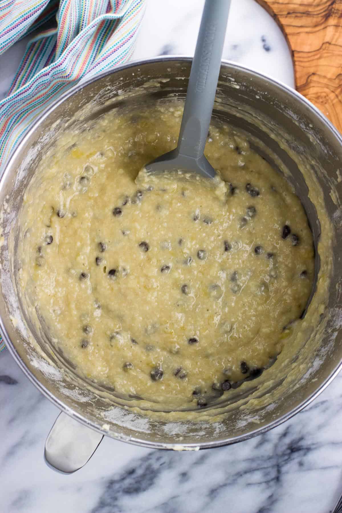 Chocolate chips stirred into the bowl of batter.