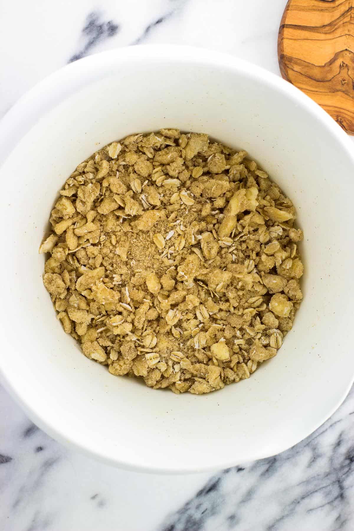 Oatmeal topping in a bowl ready to sprinkle on the fruit.