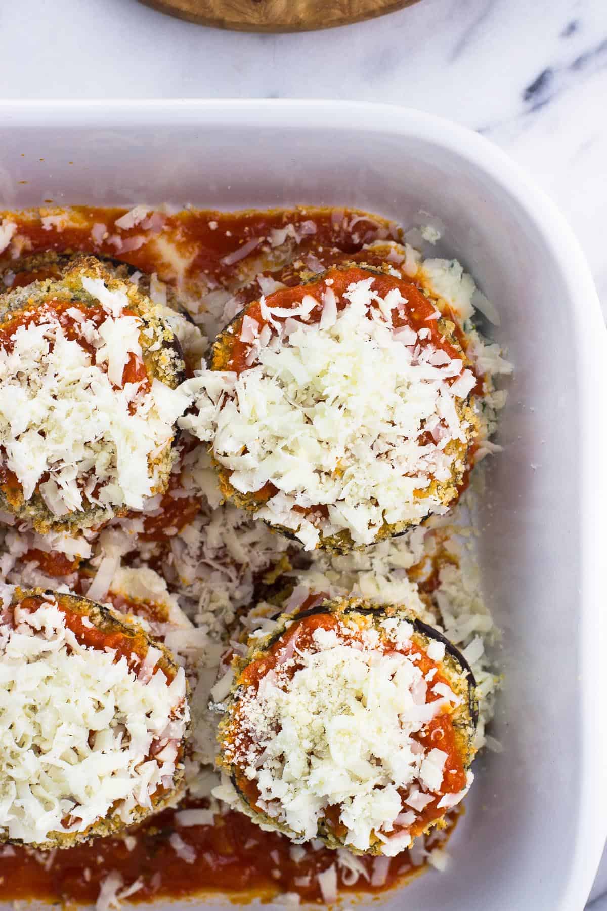 Fully-assembled eggplant stacks in the dish before cooking.