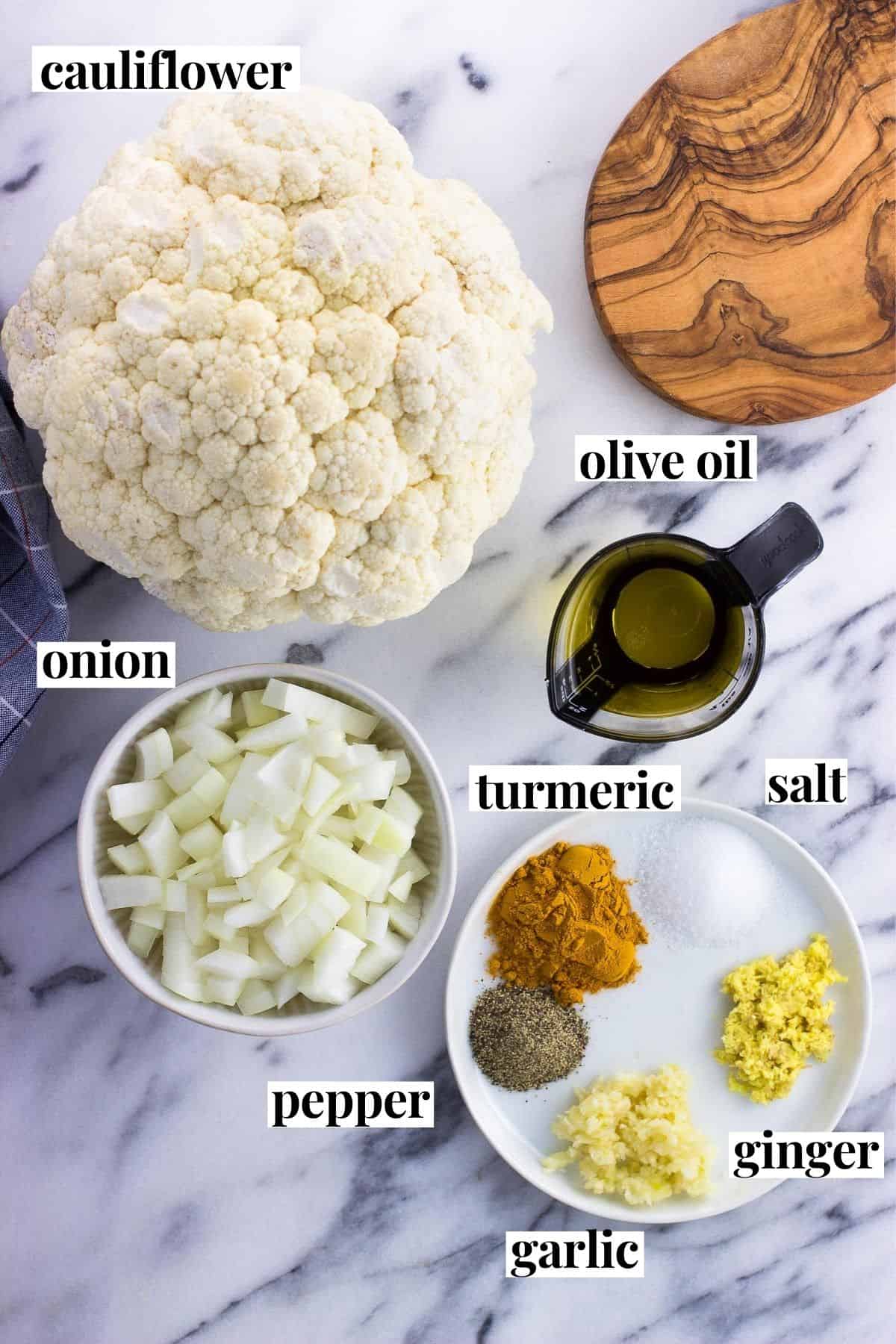 Recipe ingredients, labeled, in separate containers on a marble board.