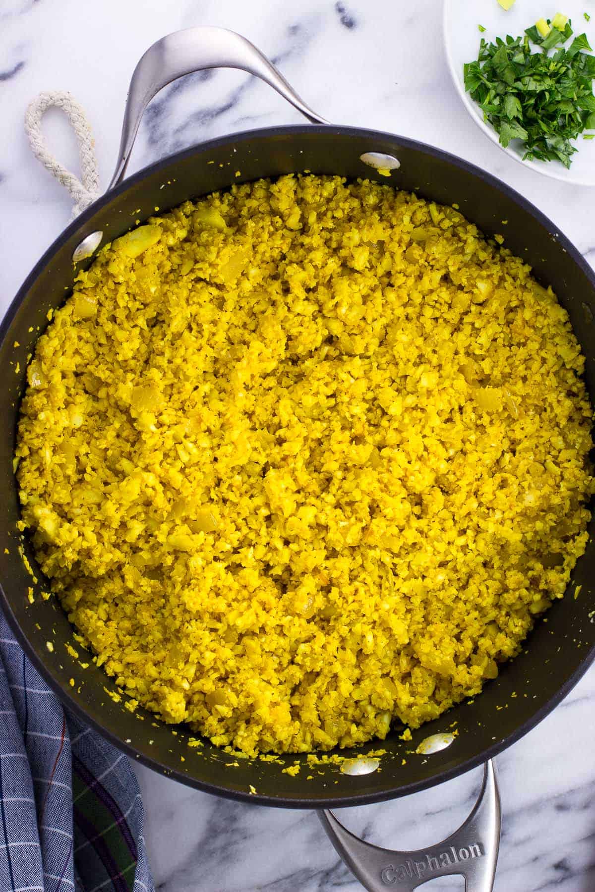 Turmeric cauliflower rice in a large pan.