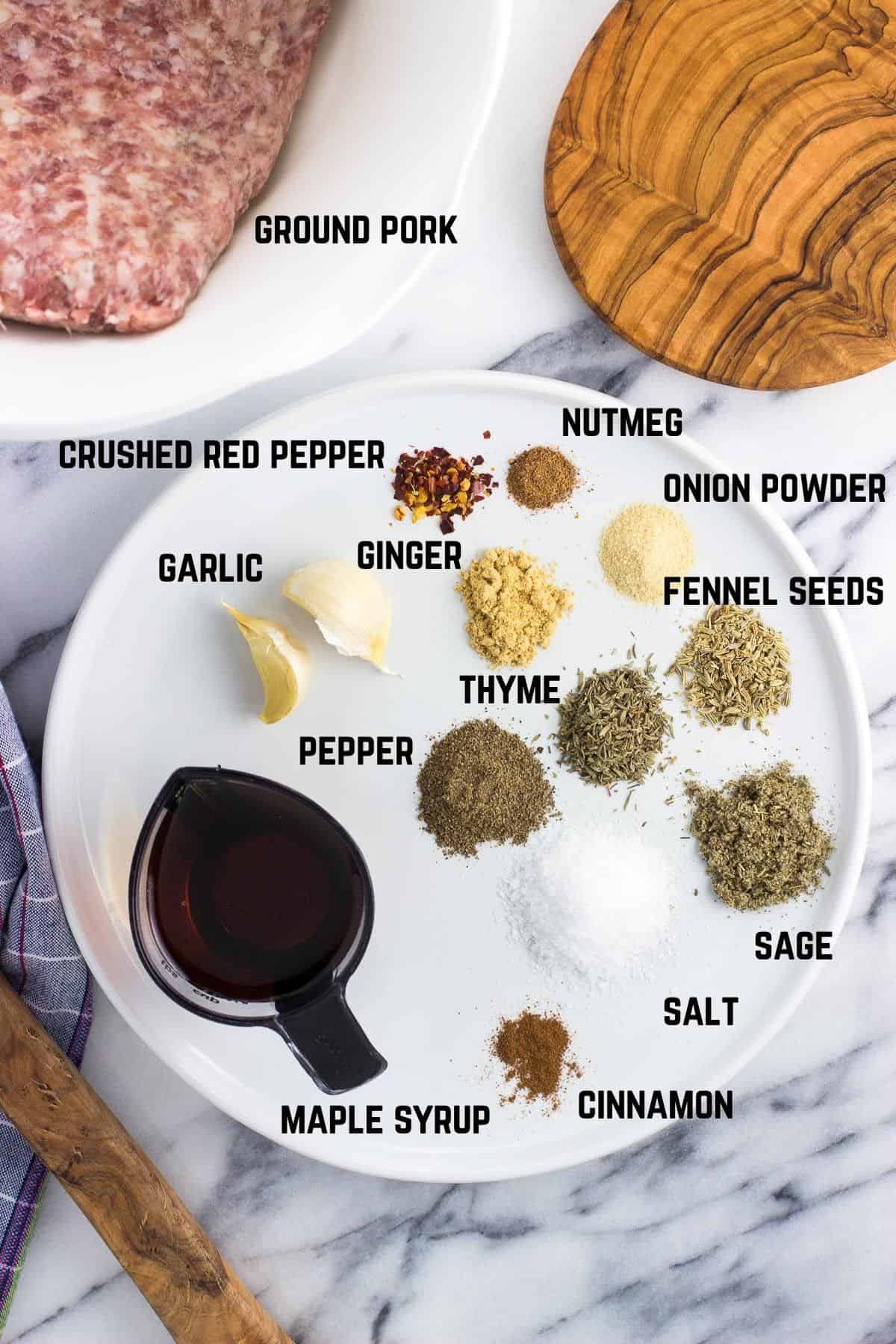 Labeled ingredients for homemade breakfast sausage in separate bowls and containers.