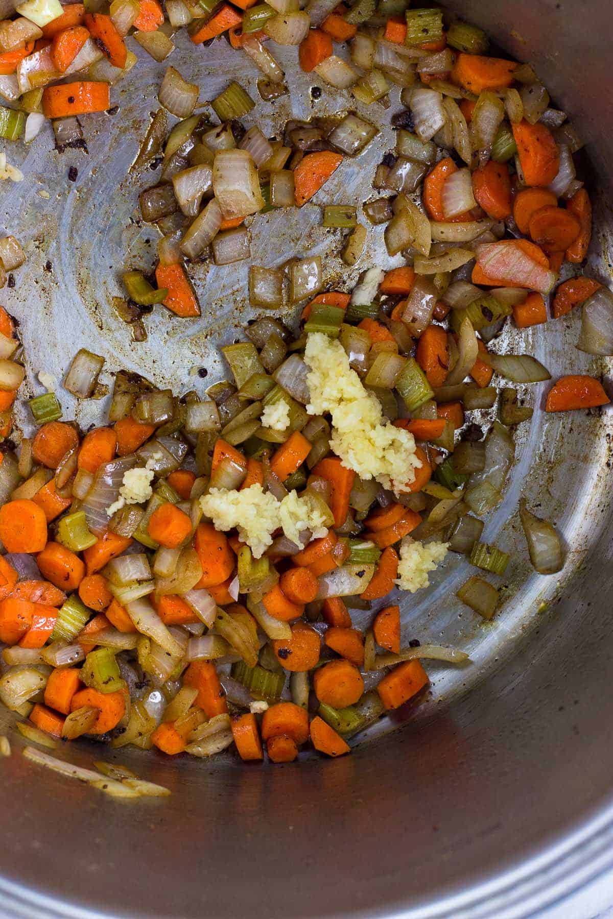 Minced garlic added to the pot with the sauteed vegetables.