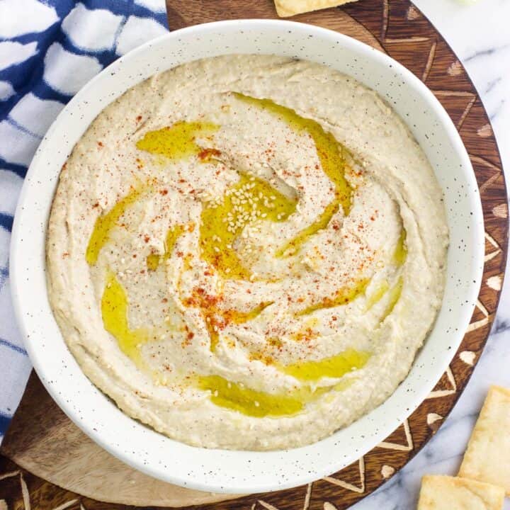 A bowl of hummus drizzled with olive oil.