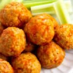 Meatballs covered in buffalo sauce in a pile.