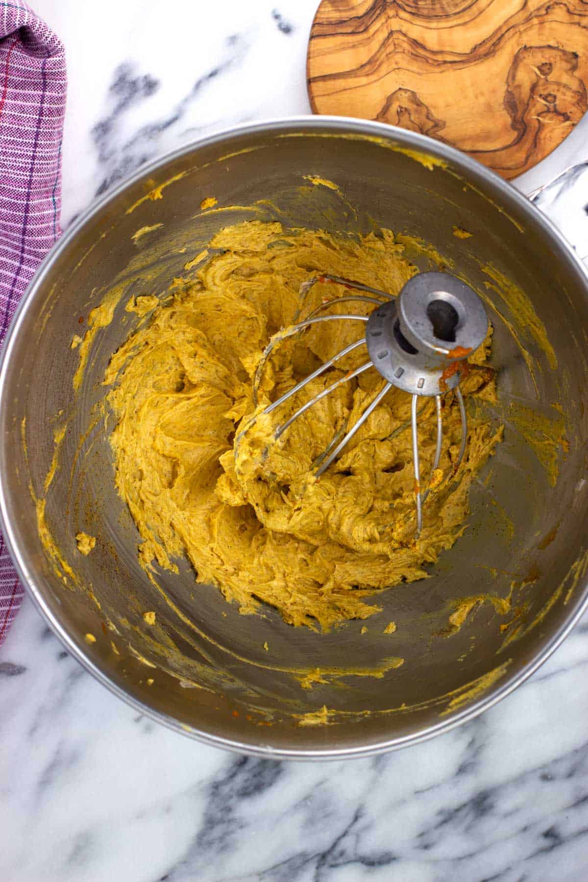 Pumpkin spice butter whipped in the bowl of a food processor.