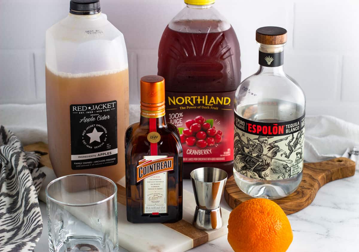 Cranberry apple margarita ingredients on a countertop.