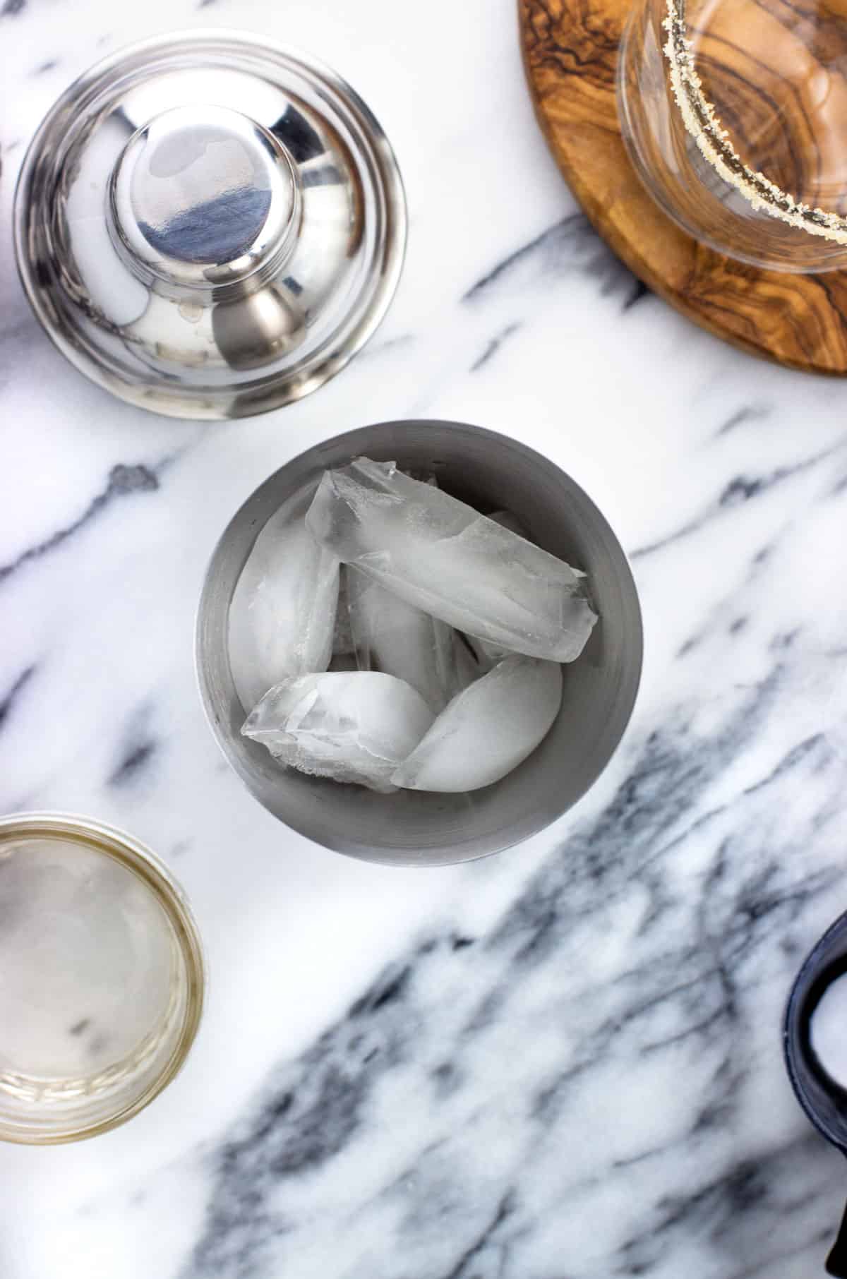 Ice cubes in a metal cocktail shaker.