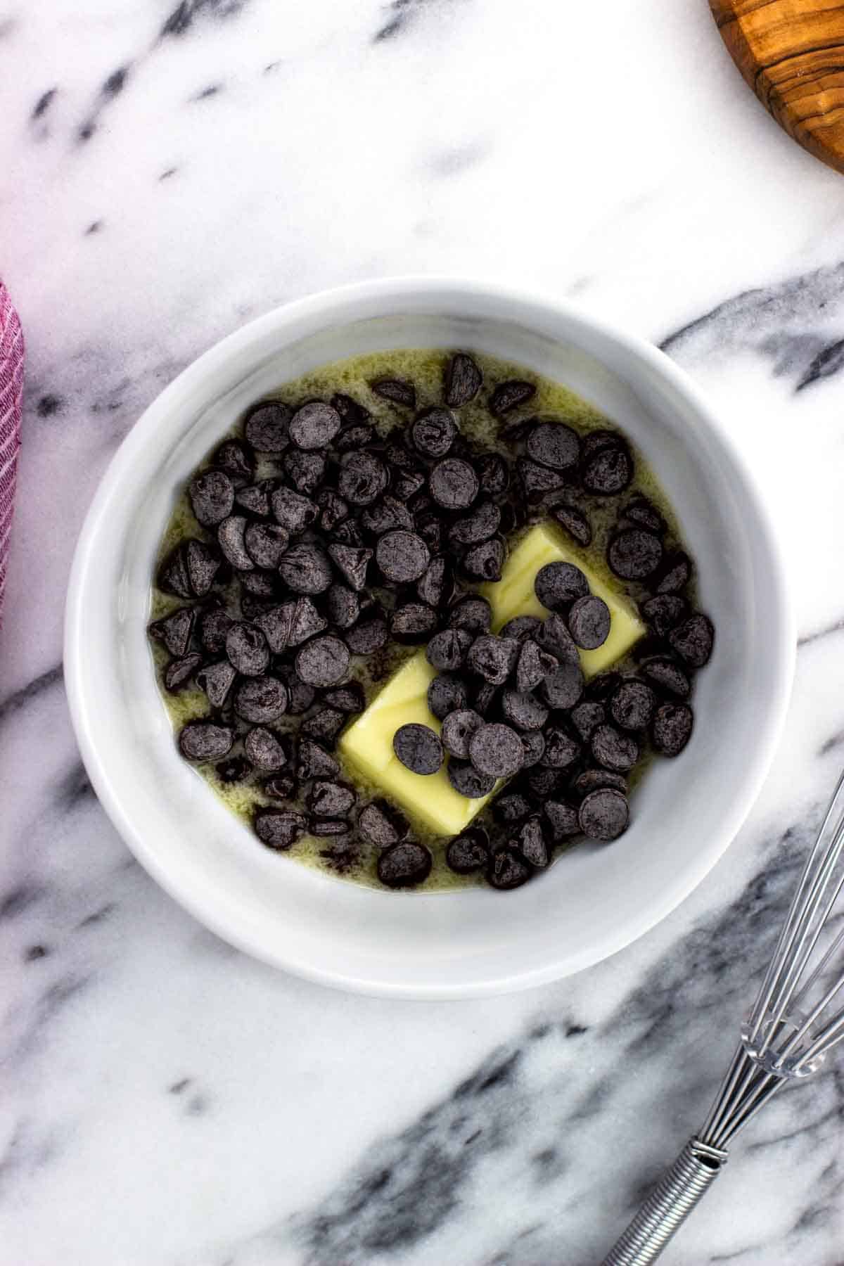 Melted butter and chocolate chips in a bowl.