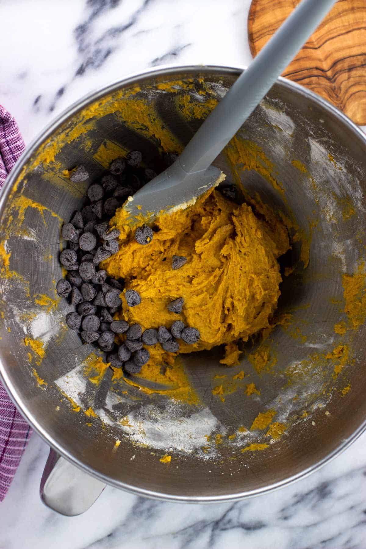 Chocolate chips added to the bowl with the pumpkin batter.