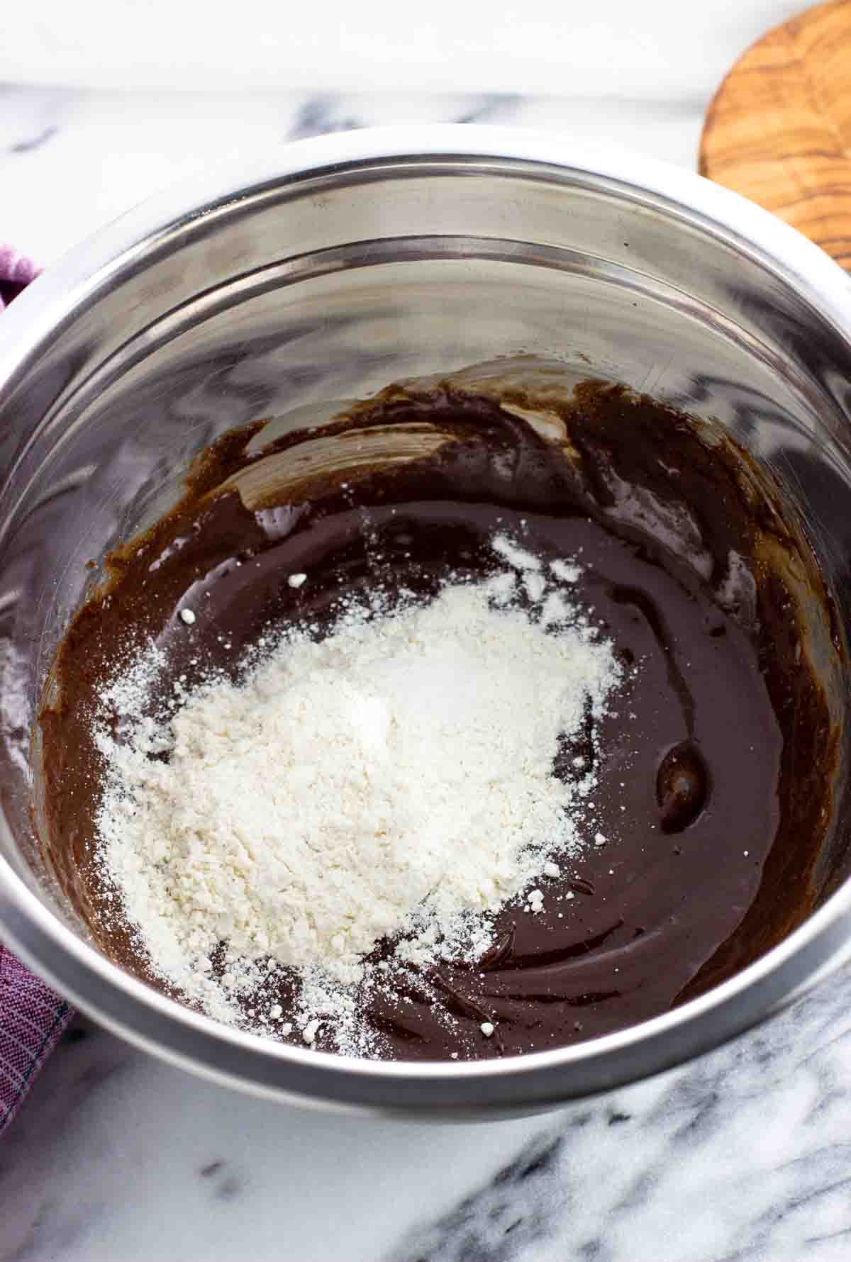 Dry brownie ingredients added to the bowl with the wet.