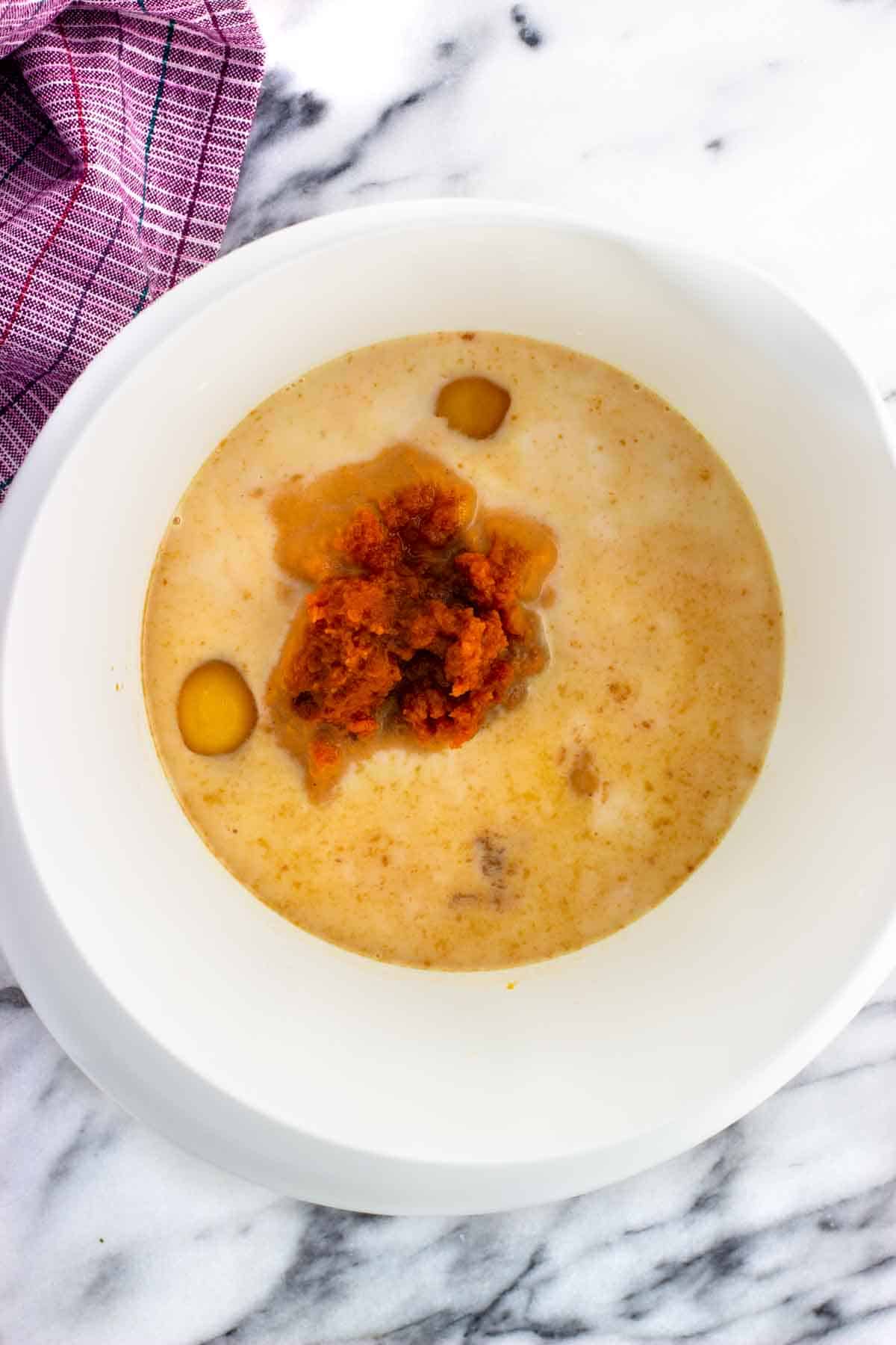 Wet ingredients added to a mixing bowl.