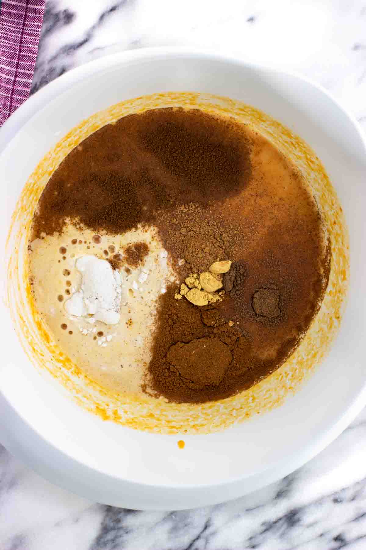 Baking powder and spices added to the mixing bowl.