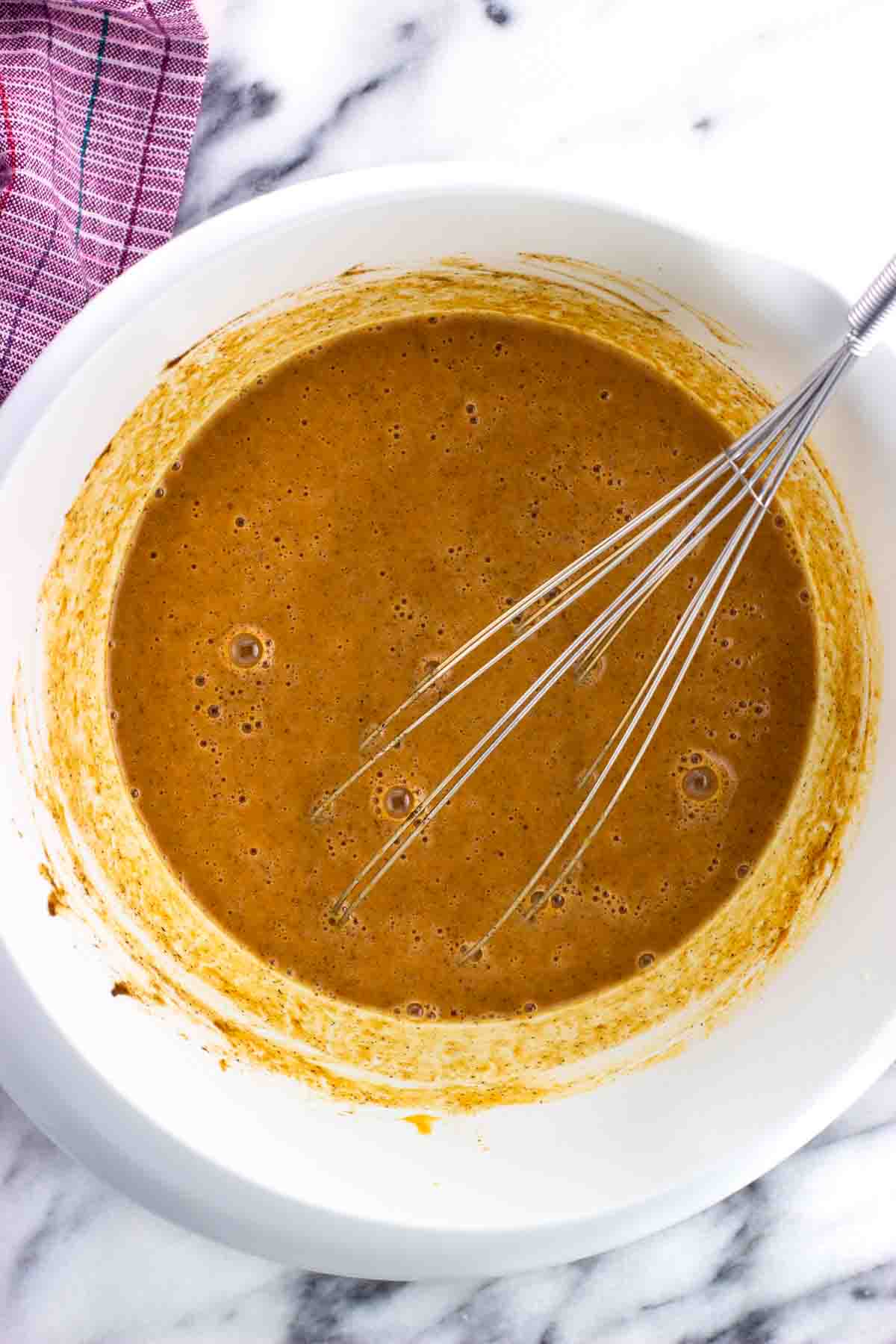 Baking powder and spices whisked into the pumpkin mixture.