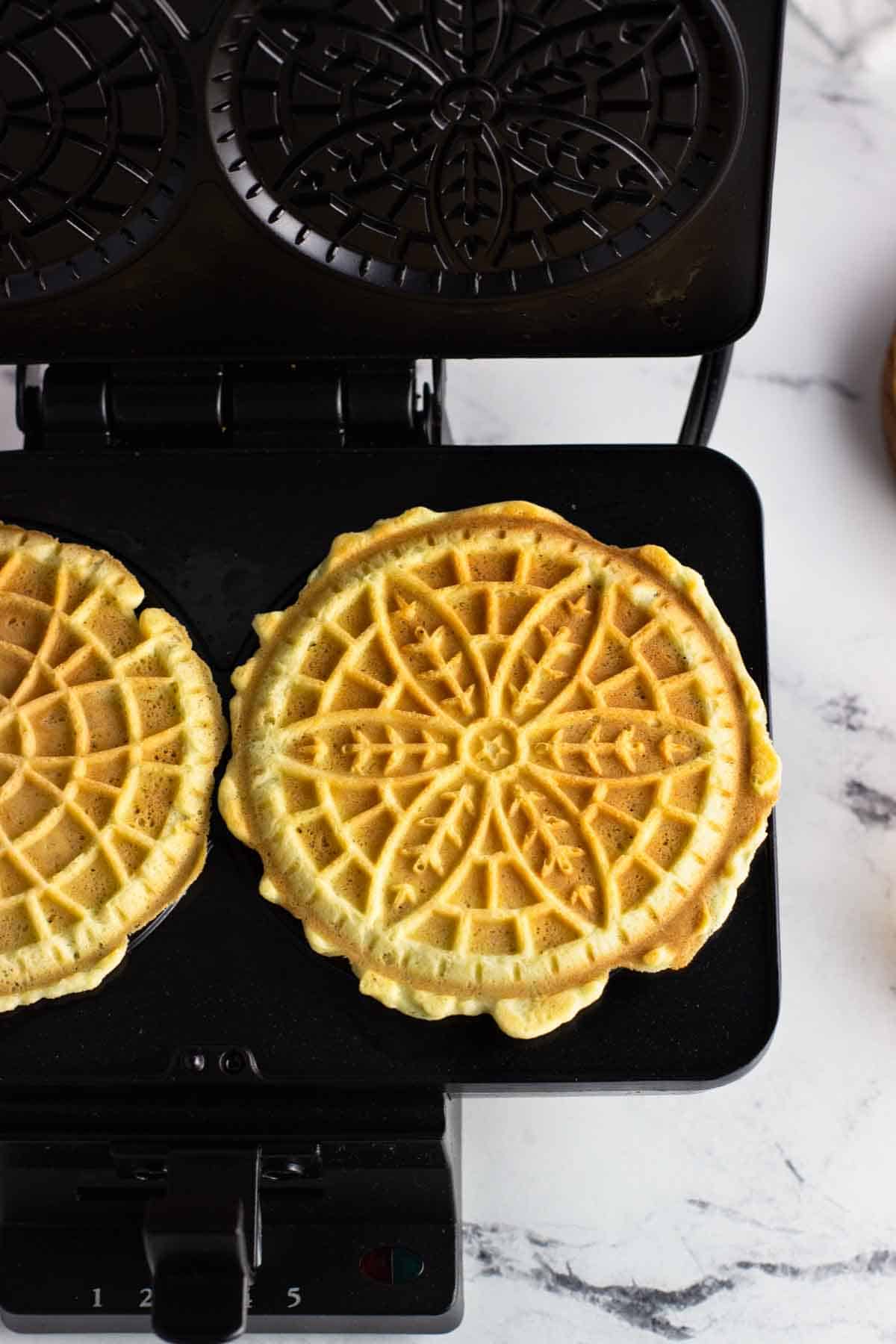 Cooked pizzelle on the pizzelle iron.