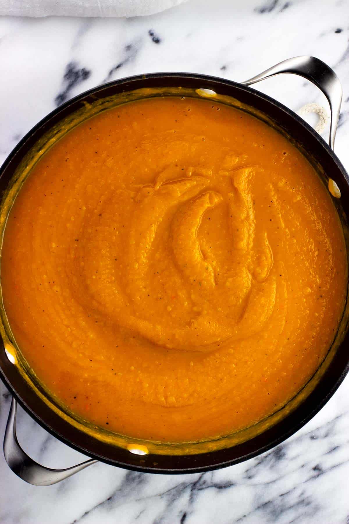 Blended butternut squash soup in a large pot.