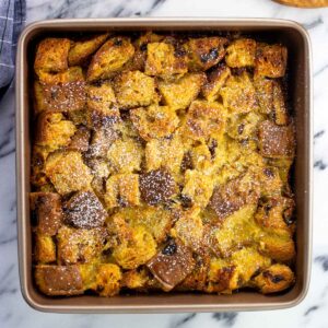 Baked panettone french toast in a square pan.