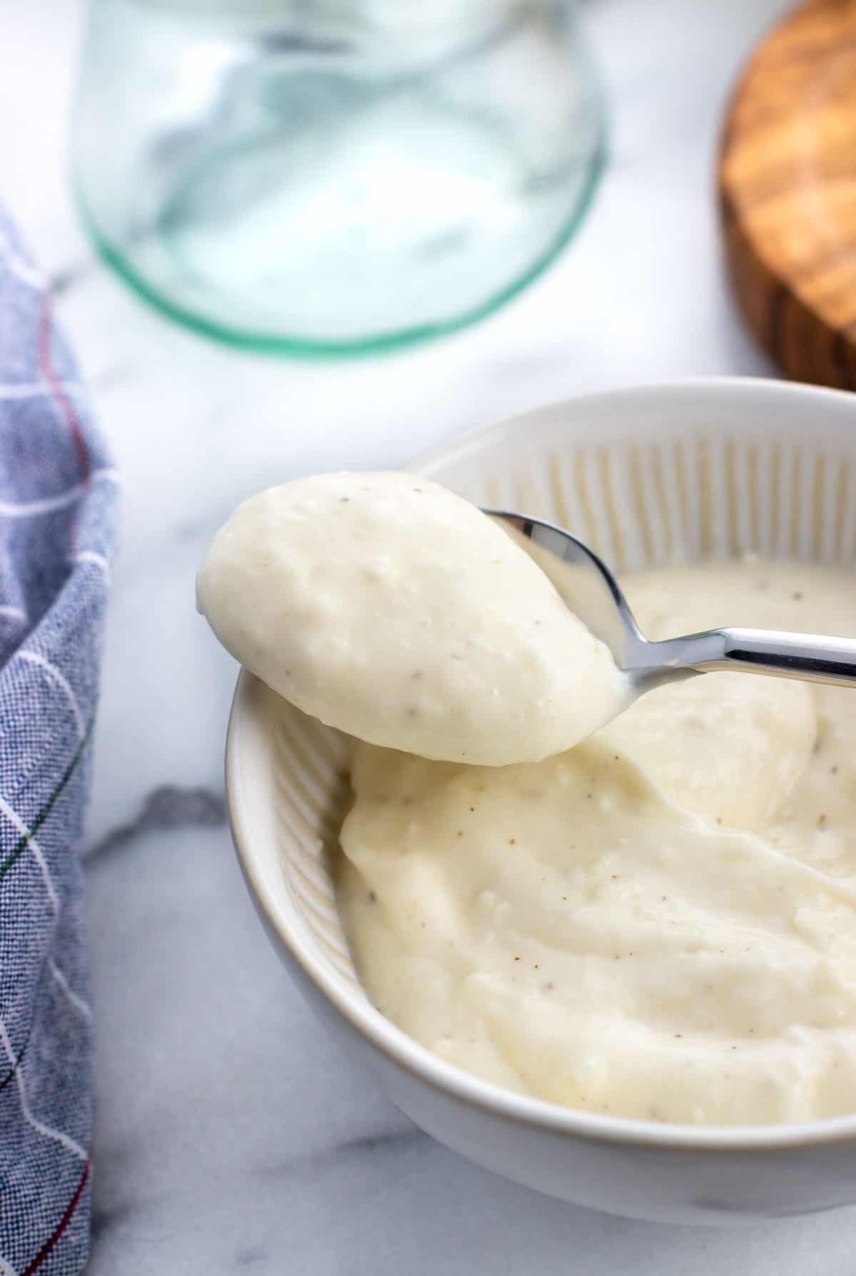 A close-up of a dollop of aioli on a spoon.