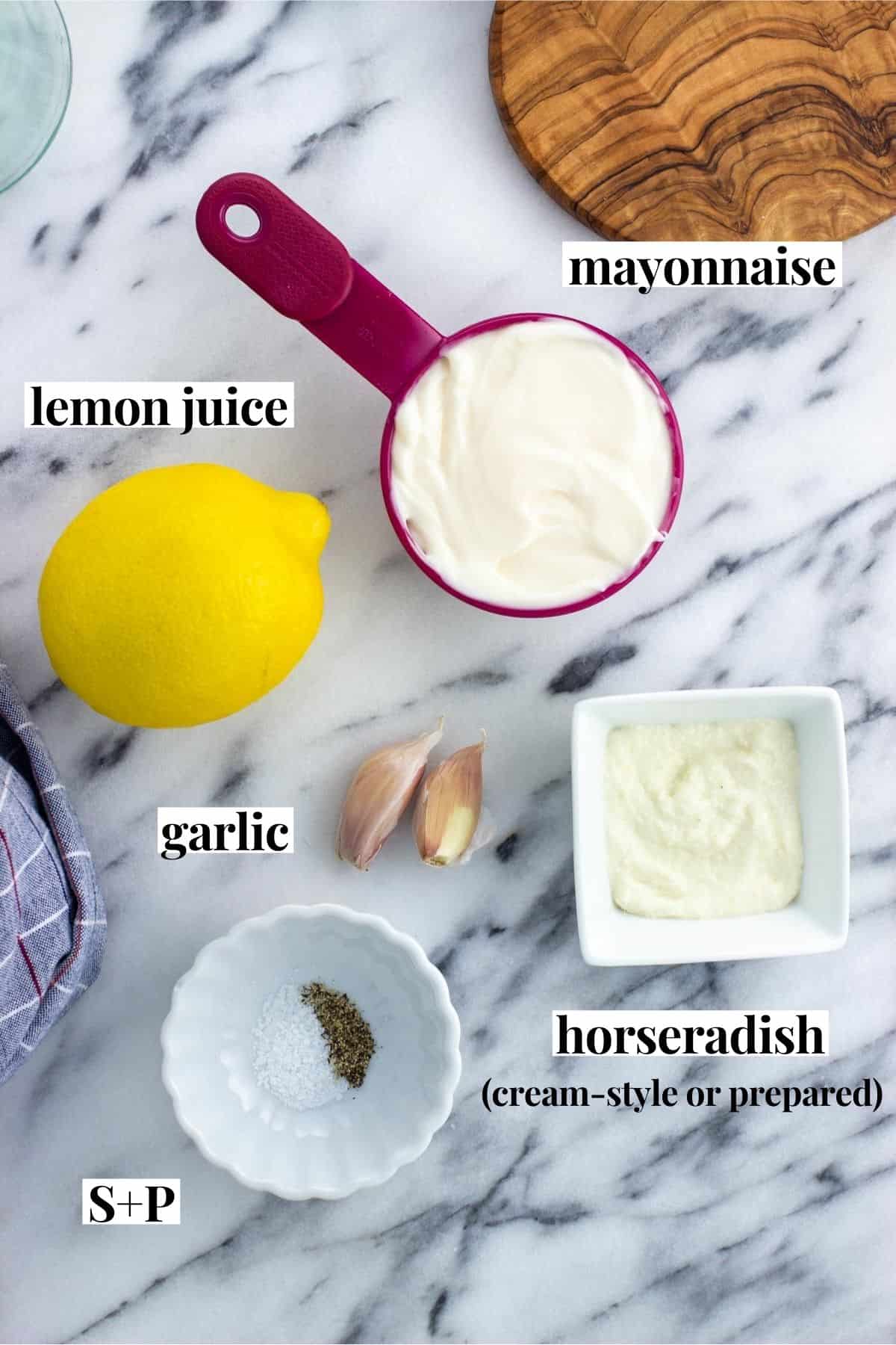 Labeled horseradish aioli ingredients on a marble board.