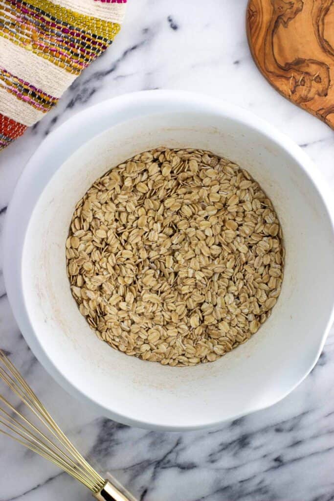 Oats and dry ingredients in a mixing bowl.