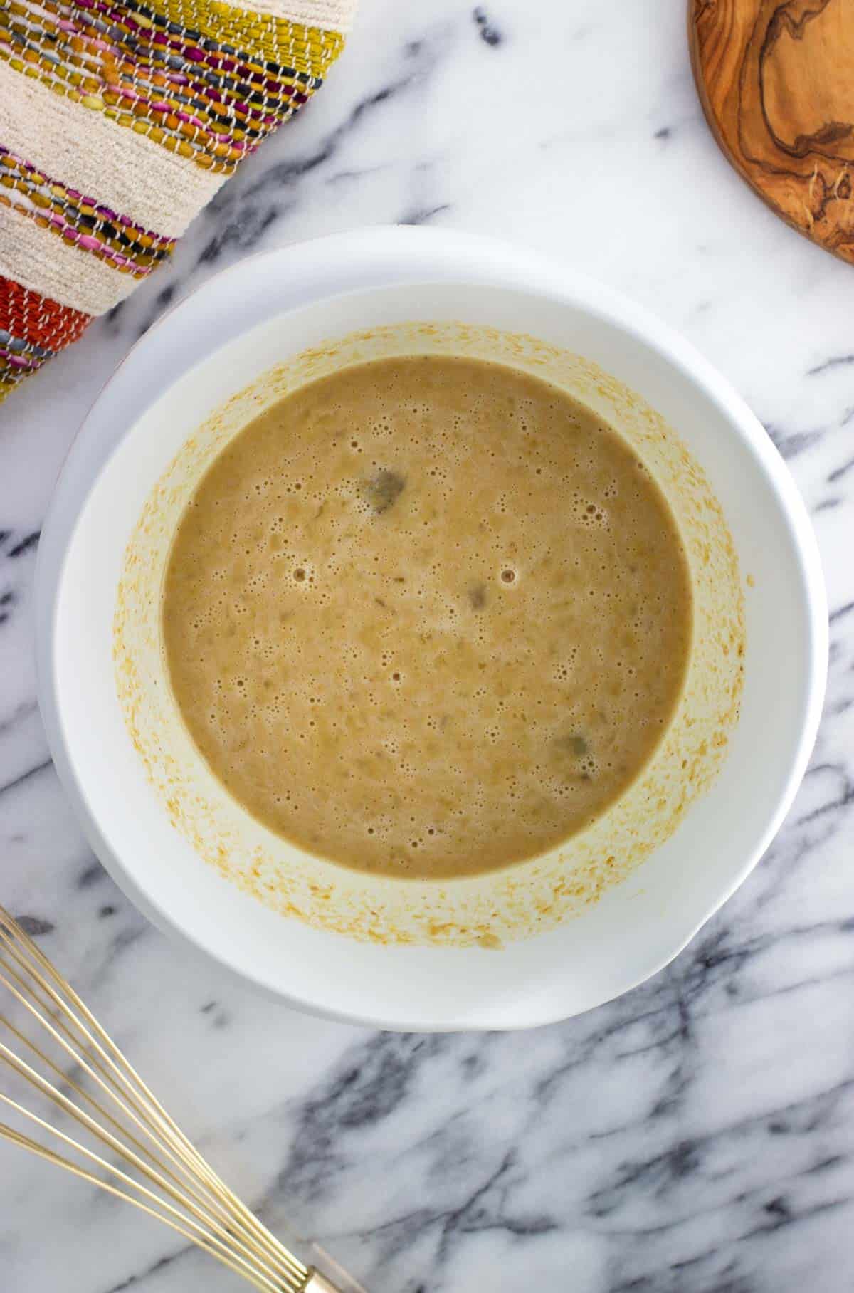 Well mixed together wet ingredients in a bowl.